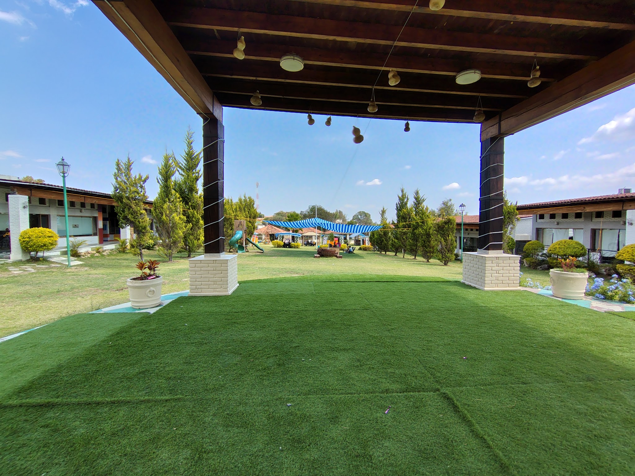 A covered garden shelter looking out over the lawn at PLAZA MACLOVIA
